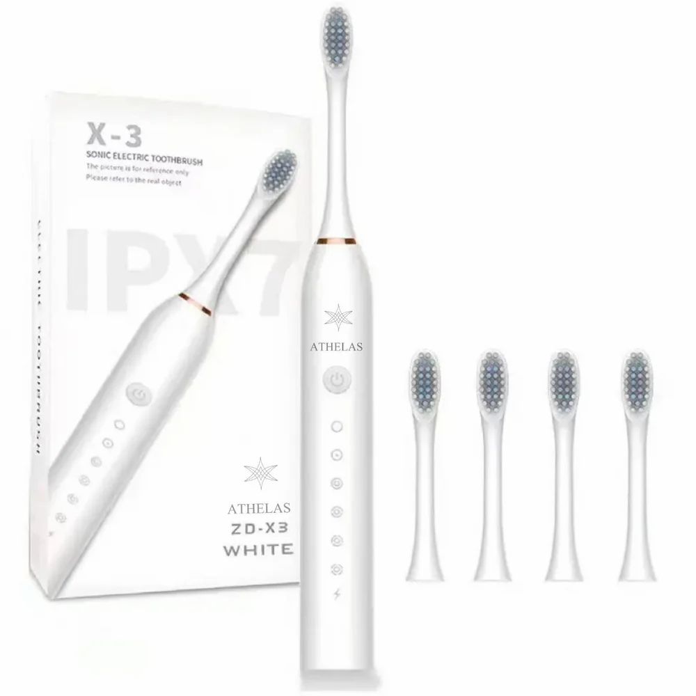 White electric toothbrush with packaging and additional brush heads on a white background
