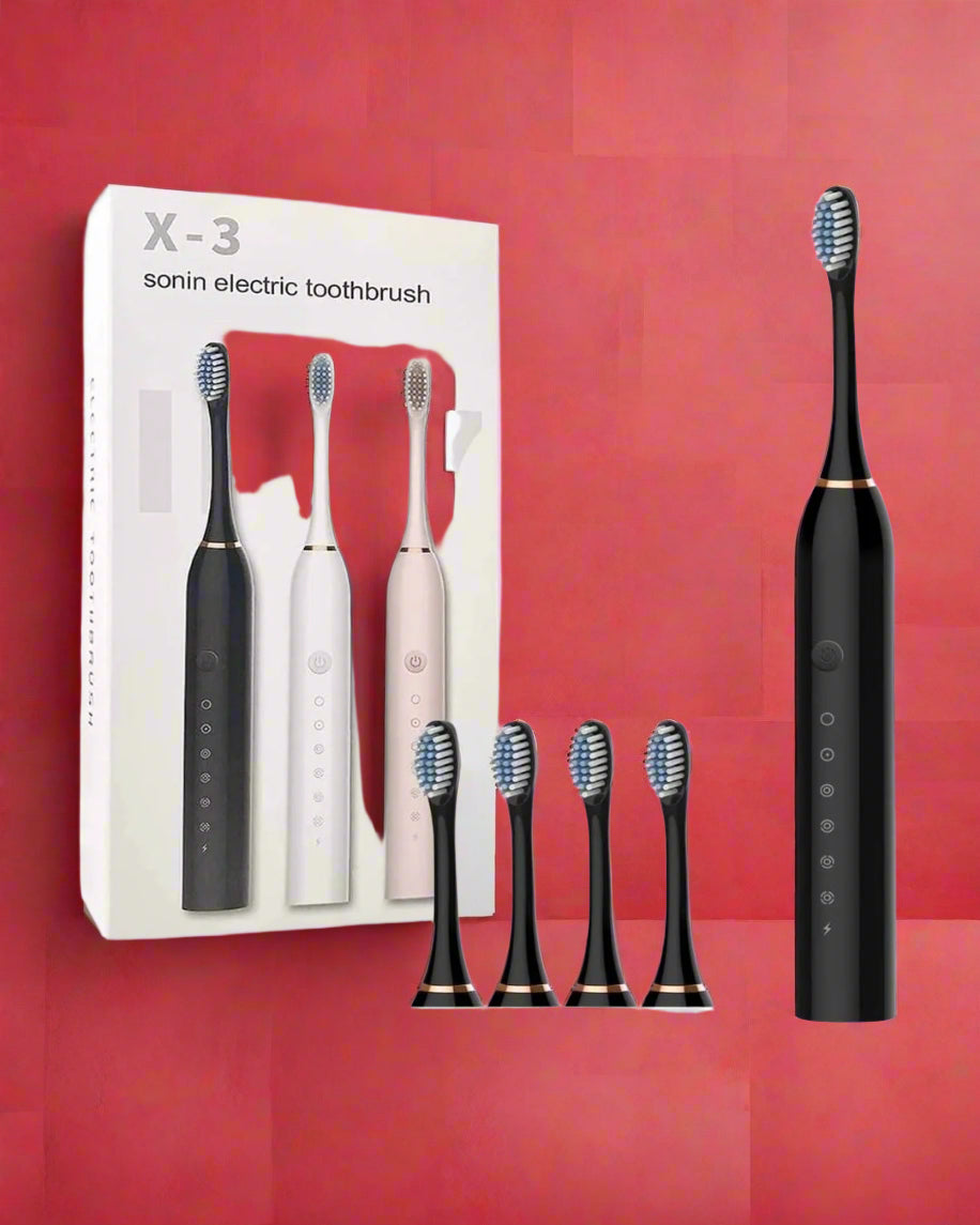 Black electric toothbrush with packaging on a pink background