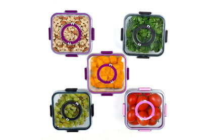 Set of five food storage containers with different contents on a white background
