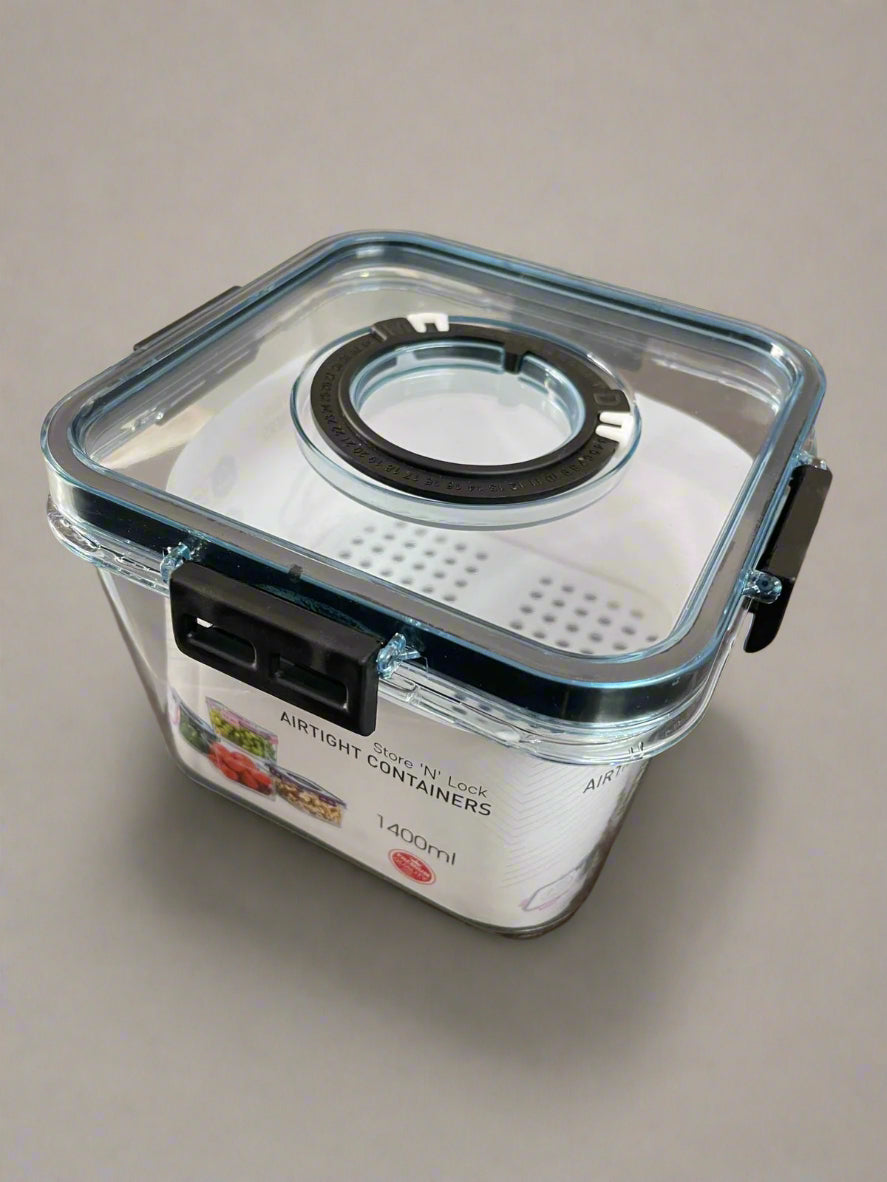 Clear airtight container with black sealing ring on a beige background